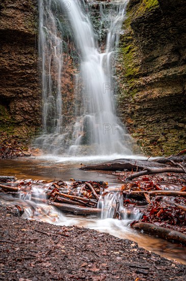 The waterfall in the Rautal forest at Burschenplatz in winter, Jena, Thuringia, Germany, Europe