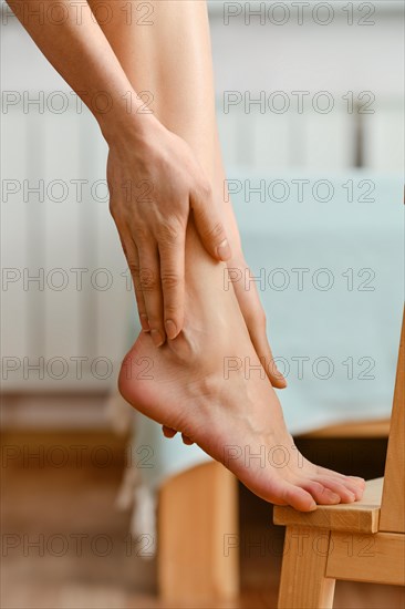 Closeup view of female hands massaging foot