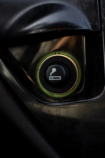 Vertical Close up of the car cigarette lighter socket.modern car interior: parts, buttons, knobs