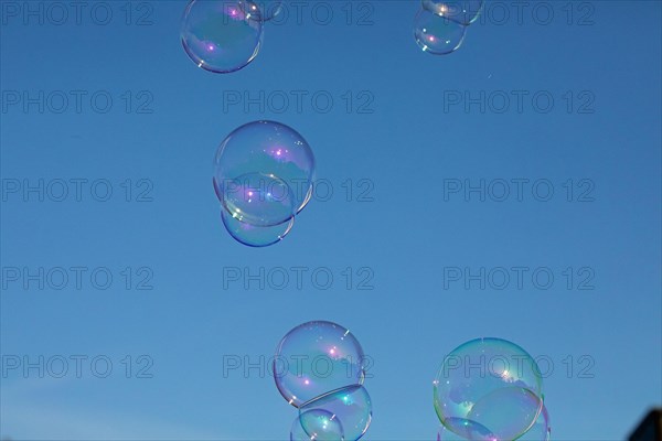 Soap bubbles several coloured films of soapy water on top of each other in front of a blue sky