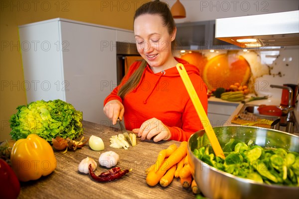 Vegan cooking: Young woman prepares lamb's lettuce