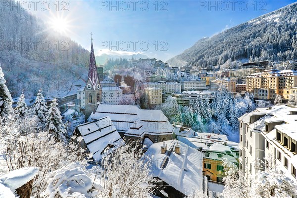 Snow-covered winter panorama of the town centre with parish church, Bad Gastein, Gastein Valley, Hohe Tauern National Park, Salzburg province, Austria, Europe