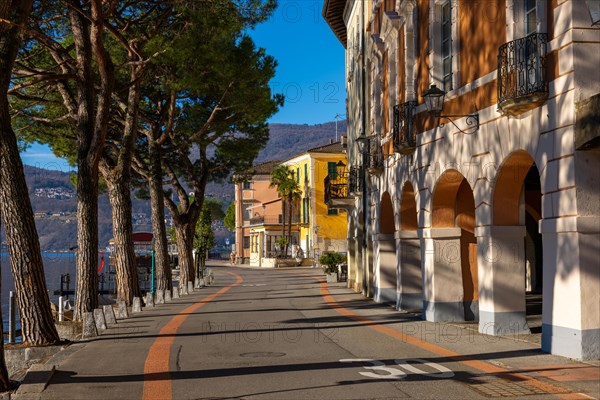 Old Beautiful Town with Building and Trees on the Waterfront on Lake Lugano in a Sunny Day with Mountain in Morcote, Ticino, Switzerland, Europe