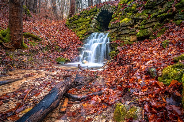 Waterfall in the Rautal forest in Jena in winter, Jena, Thuringia, Germany, Europe