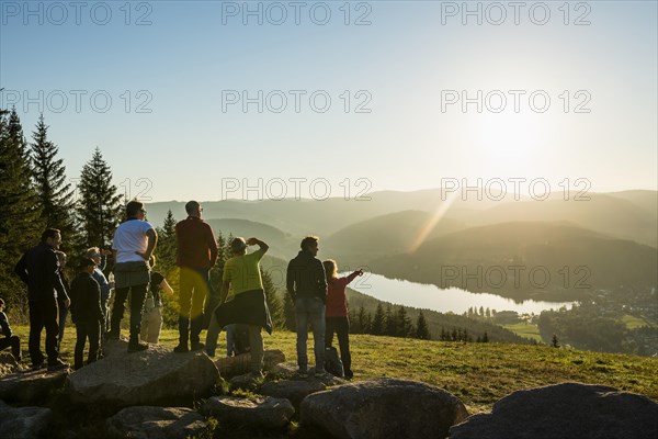 Hiking group, view from Hochfirst to Titisee and Feldberg, sunset, near Neustadt, Black Forest, Baden-Wuerttemberg, Germany, Europe