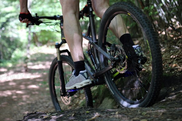 Close-up of a mountain biker in difficult terrain