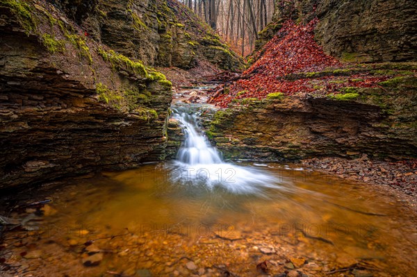 Waterfall in the Rautal forest in Jena in winter, Jena, Thuringia, Germany, Europe