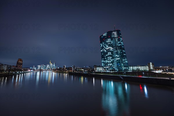 The lights of the European Central Bank (ECB) in Frankfurt am Main shine in the evening, Osthafen, Frankfurt am Main, Hesse, Germany, Europe