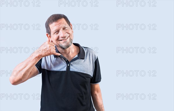 Cheerful senior man making call gesture with hand. Smiling mature man making telephone gesture with hands isolated