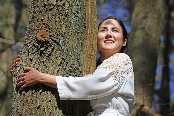 Young woman bathing in the forest (Shinrin Yoku), nature therapy from Japan