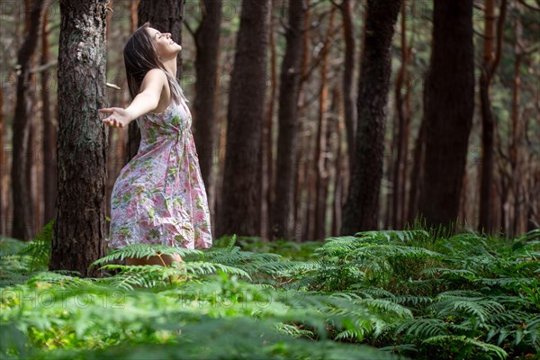 Young woman bathing in the forest (Shinrin Yoku), nature therapy from Japan