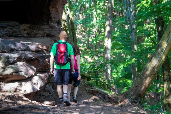 Hikers in the Dahner Felsenland . The many red sandstone rock formations characterise this region