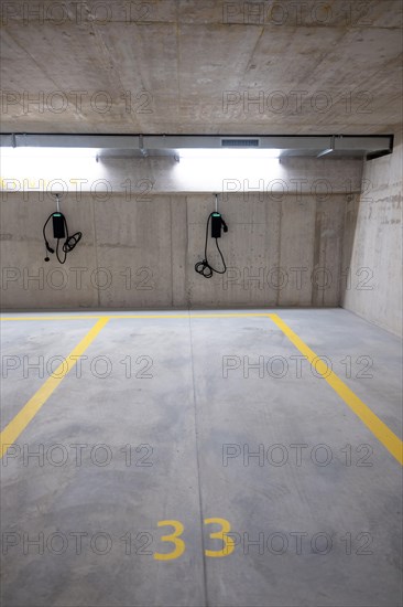 Illuminated Underground Parking Lot with Number and Electric Car Charger in Switzerland