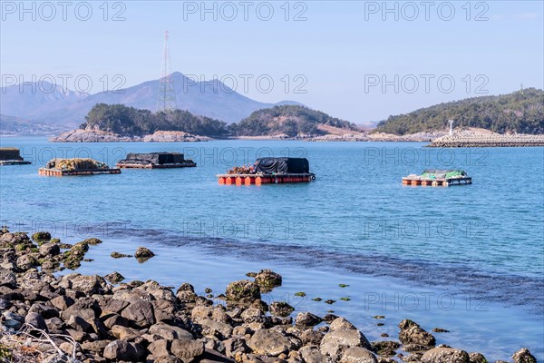 Floating docks loaded with fishing gear in water off island coastal seaport in Yeosu, South Korea, Asia