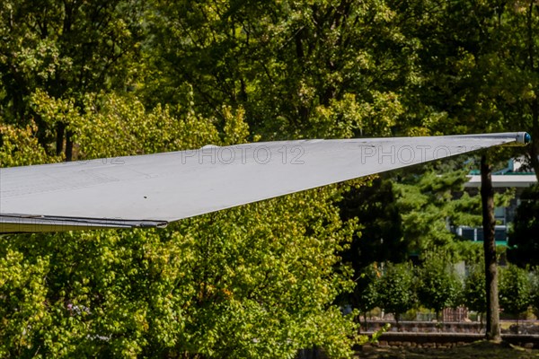 Starboard wingtip of jet fighter on display in public park