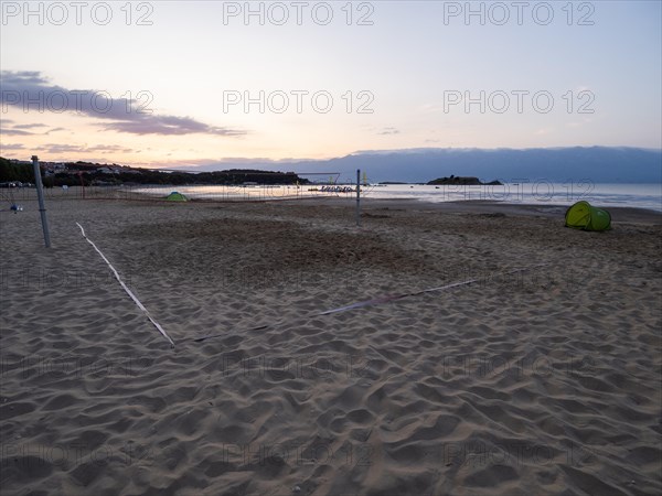 Morning atmosphere on the beach at sunrise, beach volleyball court, Lopar, island of Rab, Kvarner Gulf Bay, Croatia, Europe