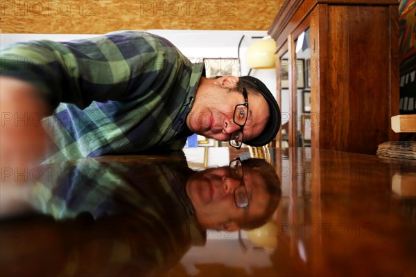 Furniture restorer polishes a table