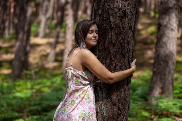 Young woman bathing in the forest (Shinrin Yoku), nature therapy from Japan