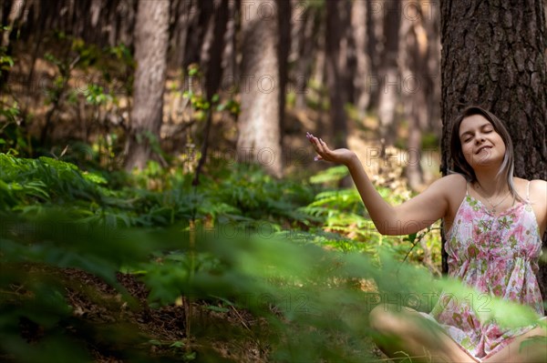 Young woman bathing in the forest (Shinrin Yoku), nature therapy from Japan