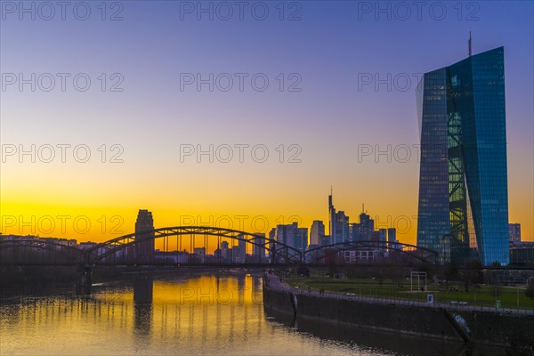 Evening atmosphere at the European Central Bank (ECB) with skyline behind the Deutschherrnbruecke from the Arthur-von-vineyard-Steg, golden hour, Frankfurt am Main, Hesse, Germany, Europe