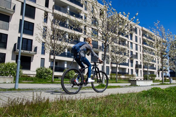 Young woman with bicycle in the city