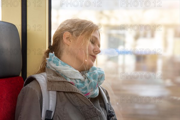 Close-up of a young woman on a train