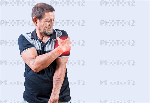Elderly person suffering with arm pain. Senior man with arm pain isolated