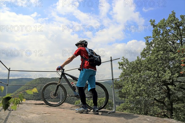 Mountain biker enjoys the view of the Palatinate Forest above Neustadt an der Weinstrasse