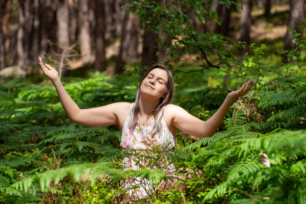 Young woman bathing in the forest (Shinrin Yoku), nature therapy from Japan