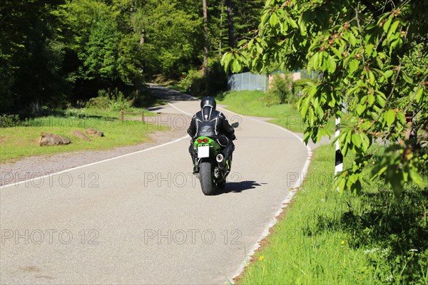 Sporty motorcyclist on a trip into the countryside (Edenkoben Valley, Palatinate Forest)