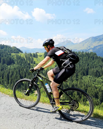 Mountain bikers in the Kitzbuehel Alps with alternating views of the Wilder Kaiser and the Kitzbueheler Horn
