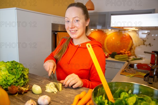 Vegan cooking: Young woman prepares lamb's lettuce