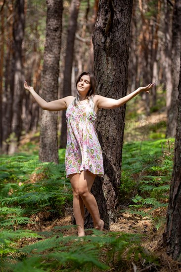 Young woman bathing in the forest (Shinrin Yoku), nature therapy from Japan