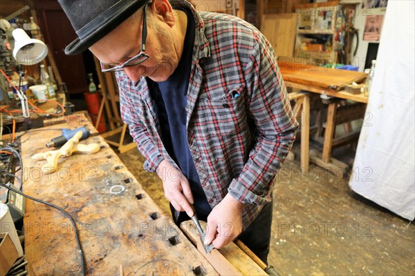 Furniture restorer in his workshop