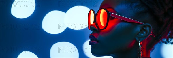 Woman with trendy glasses in profile against a background with blue neon bokeh lights creating a nocturnal mood, AI generated, AI generated
