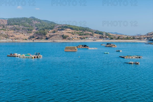 Floating docks loaded with fishing gear in water off island coastal seaport in Yeosu, South Korea, Asia