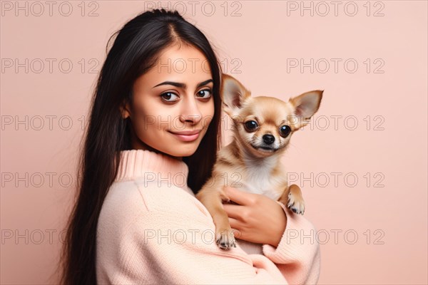Young woman with cute chihuahua dog on pink studio background. KI generiert, generiert AI generated