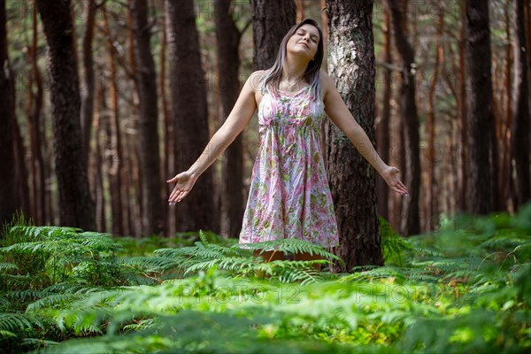 Young woman bathing in the forest (Shinrin Yoku), nature therapy from Japan