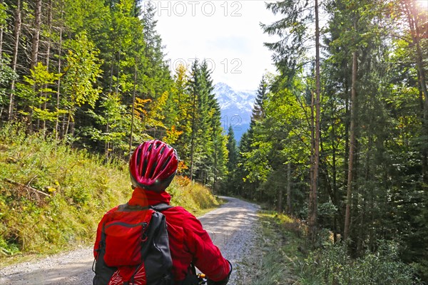 Mountain biker looks towards the Zugspitze in the background