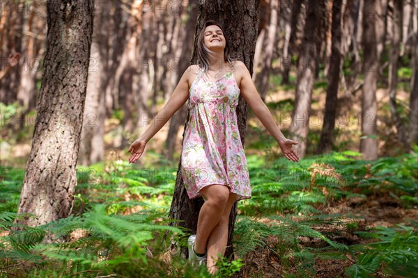 Young woman bathing in the forest (Shinrin Yoku), nature therapy from Japan