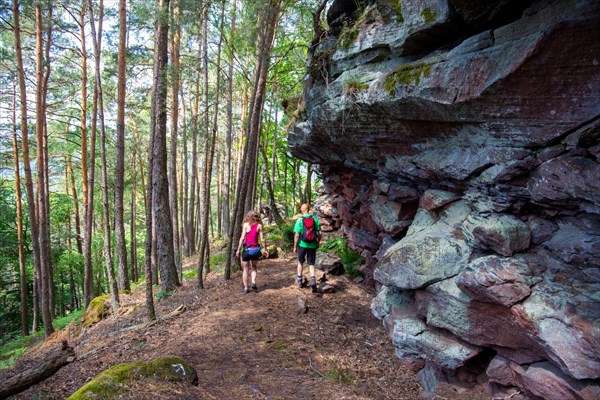 Hikers in the Dahner Felsenland . The many red sandstone rock formations characterise this region