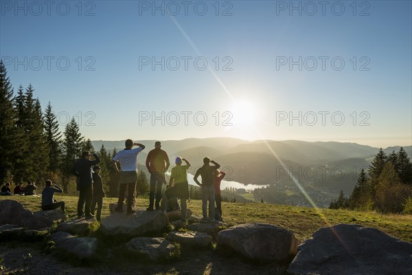 Hiking group, view from Hochfirst to Titisee and Feldberg, sunset, near Neustadt, Black Forest, Baden-Wuerttemberg, Germany, Europe