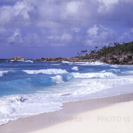 Waves in a storm on La Digue at Grand Anse beach, Seychelles, Africa