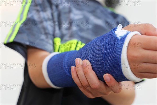 Close-up of a boy with an arm in plaster