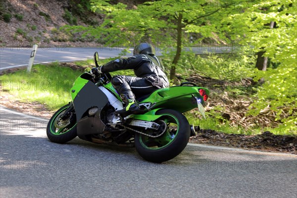 Sporty motorcyclist on a trip into the countryside (Edenkoben Valley, Palatinate Forest)