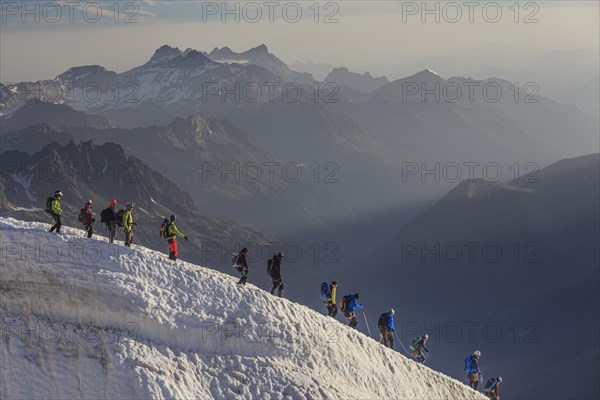 Mountaineer on glacier in the morning light, Group, Mont Blanc Massif, French Alps, Chamonix, France, Europe