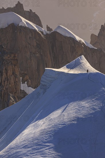 Mountaineer on glacier at sunrise, Mont Blanc Massif, French Alps, Chamonix, France, Europe