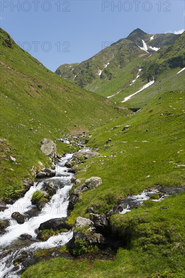 A torrent meanders through green hills and rocky landscapes, Capra River, mountain road, Transfogarasan High Road, Transfagarasan, TransfagaraÈ™an, FagaraÈ™ Mountains, Fagaras, Transylvania, Transylvania, Transylvania, Ardeal, Transilvania, Carpathians, Romania, Europe