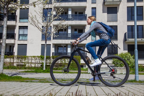 Young woman with bicycle in the city