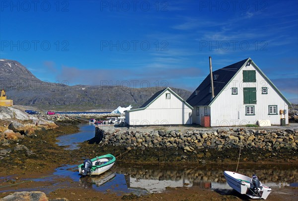 House and small boats at low tide in Nanortalik harbour, Greenland, Denmark, North America